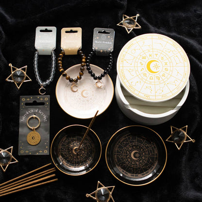 Svart rökelsehållare med guldfärgat astrologihjul