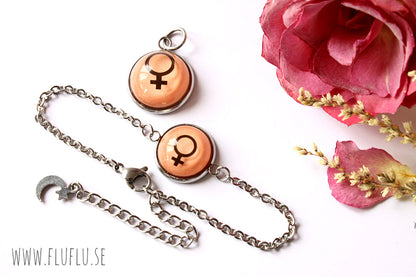 Armband med kvinnotecknet – Lila/rosa folie